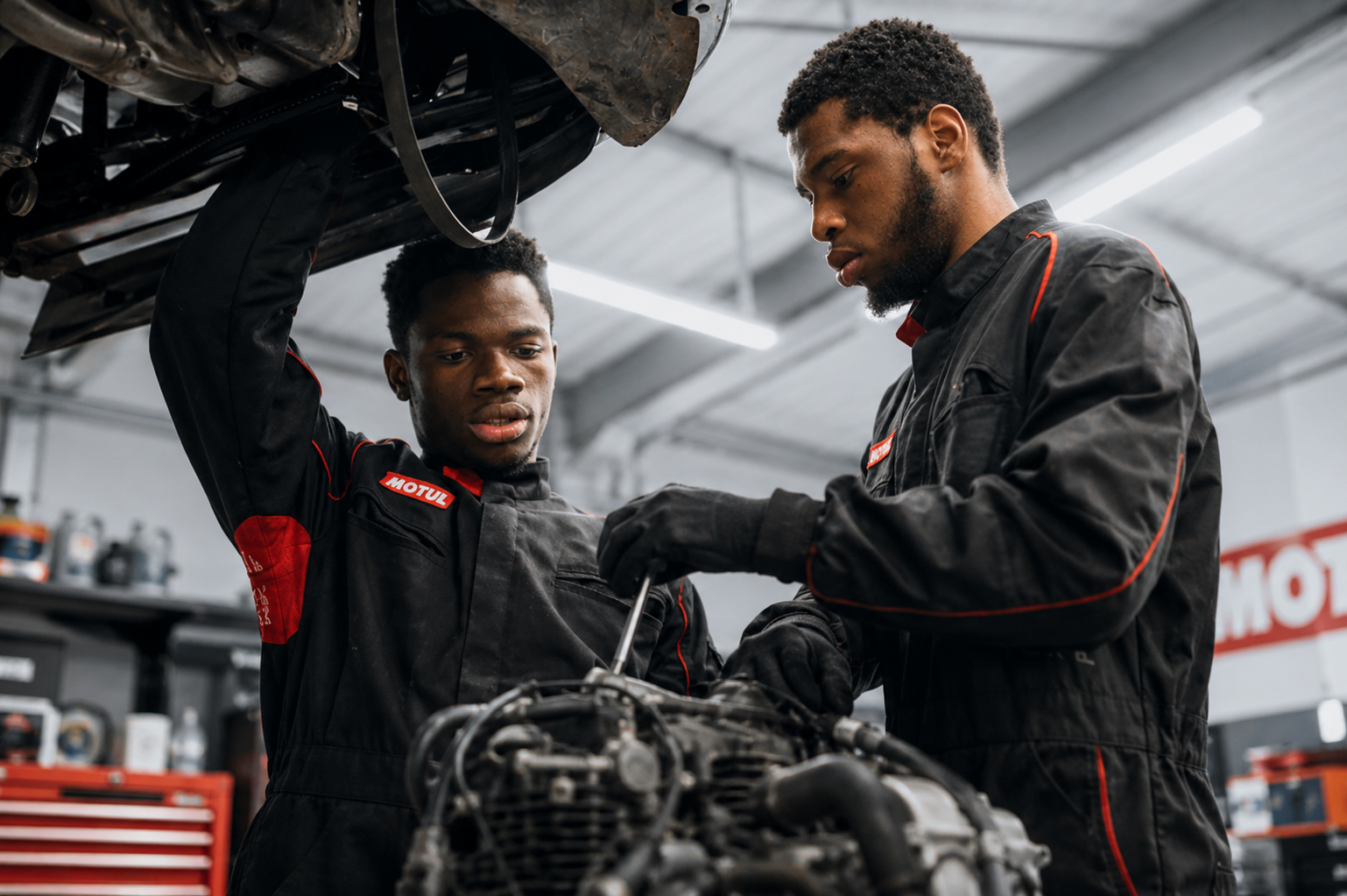Motul Corazon – Young Motorcycle Mechanics Training Two young motorcycle mechanics working together on an engine during a technical training session