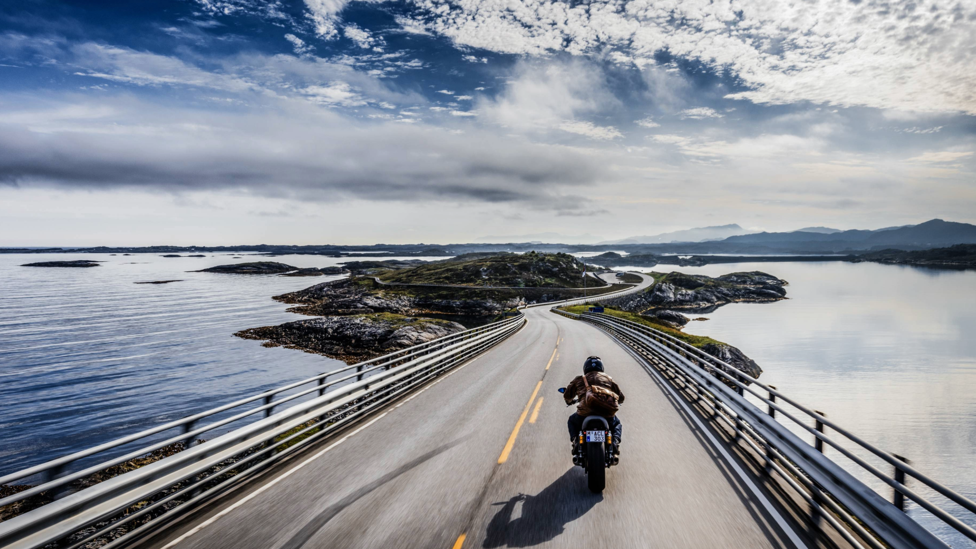 Motorcycle riding on a winding mountain road representing Motul Ride trips and tours experiences